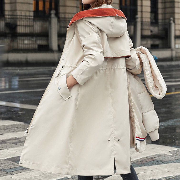 Cream waterproof women's parka jacket with orange hood trim and side zip pockets