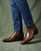 Brown leather ankle boots with buckle strap and square block heel.