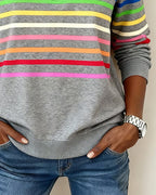 Women’s heather gray knit quarter-zip pullover with multicolor horizontal striped bands on front.