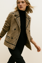 Camel and black houndstooth knit jacket with double-breasted look and patch pockets.