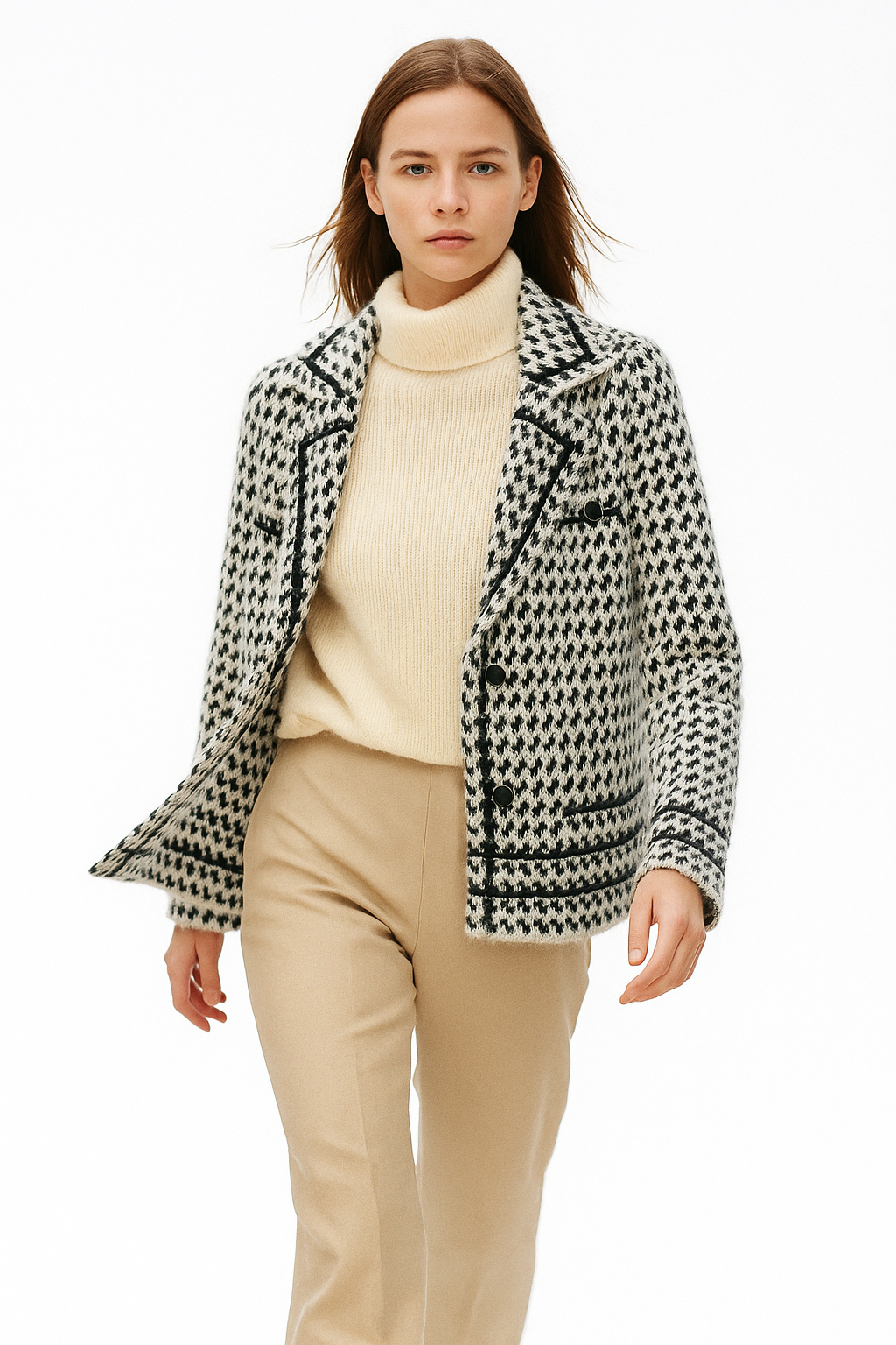 White and black houndstooth knit jacket with notched lapels and button details.