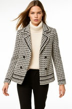 White and black houndstooth knit jacket with double-breasted buttons and ribbed trim.