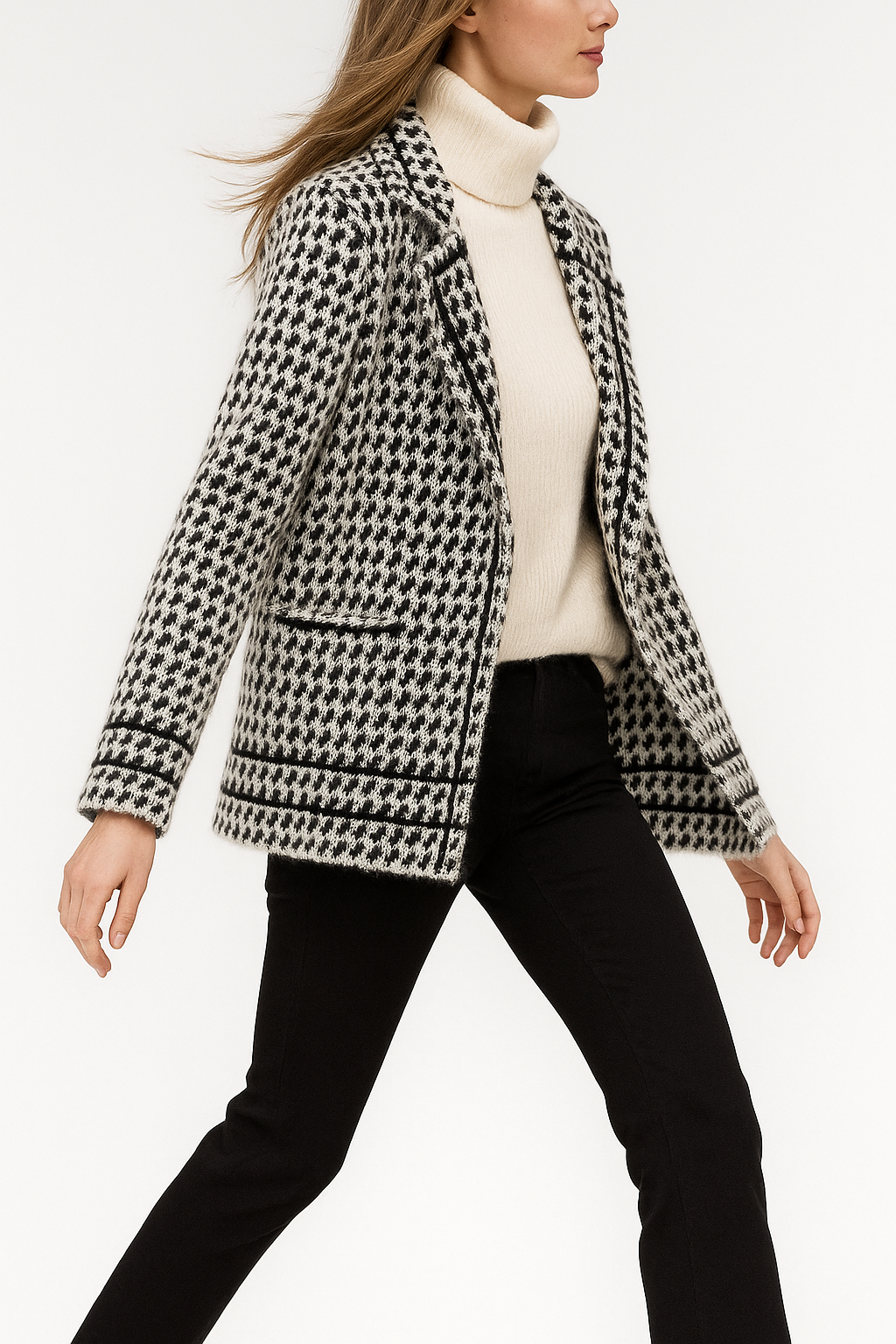 White and black houndstooth knit jacket, three-quarter side view with hem border.