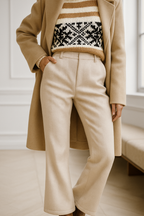 Ivory high-waisted wide-leg trousers with button closure and belt loops on model