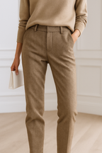 Camel high-waisted trousers with belt loops and front button closure, close-up view